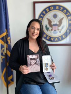 Lauren Dillion with a photo of her father, Lance Corporal Ronnie Wilson, and the replacement medals.