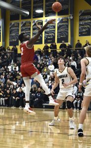 High school basketball player Morice Ayers shoots a three pointer during the Andale game